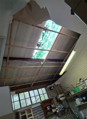 A building with a hole in the ceiling and roof