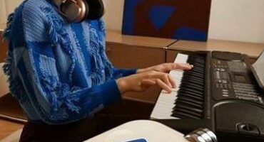 Woman playing piano with her phone turned screen down