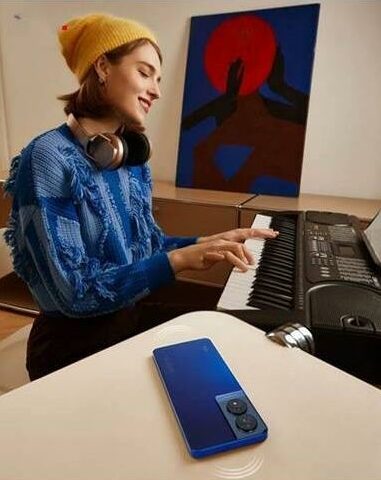 Woman playing piano with her phone turned screen down