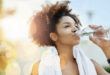 Brown woman drinking water from a bottle