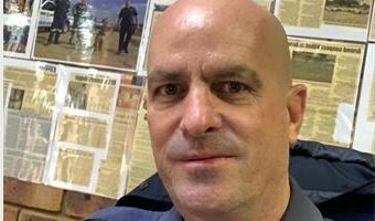 Bald man in a police uniform