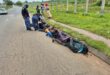Group of men lying on the road