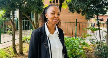 Black woman standing in a garden setting