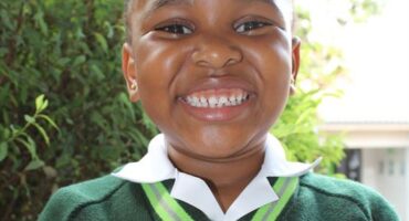 Black girl wearing a green jersey