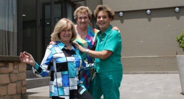 Three women smiling at the camera