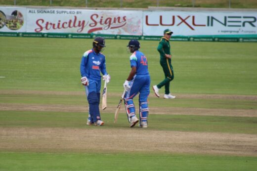 Batsmen wearing blue uniforms