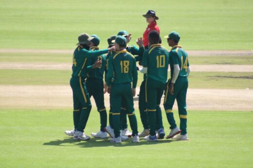 Cricket players huddled in a group