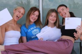 Four girls holding envelopes