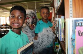 Two boys with a person dressed as a wolf