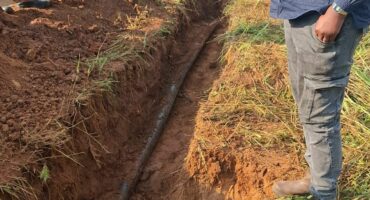 Man standing at a trench