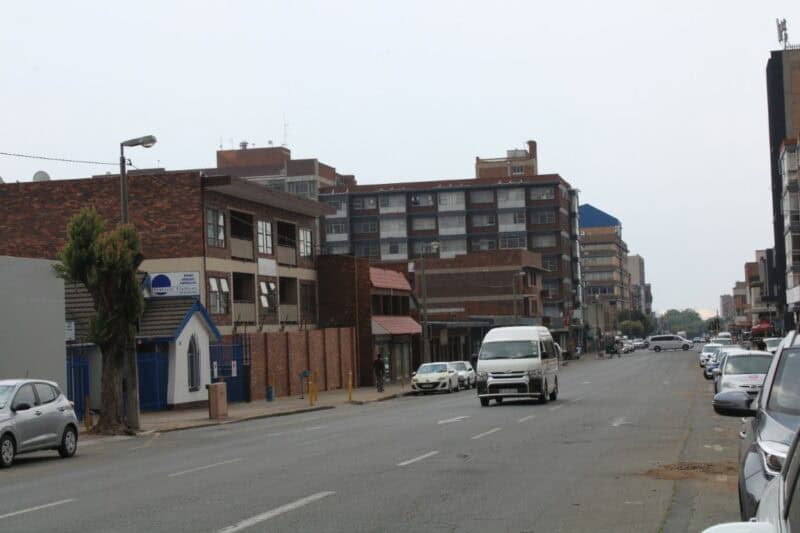 City road with cars parked on the side of the road