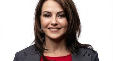 Woman with dark hair and red blouse