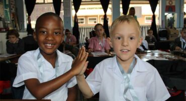 Two boys giving each other a high-five