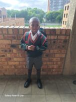Black boy wearing a school uniform