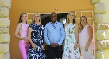 A group of four white women and one black man