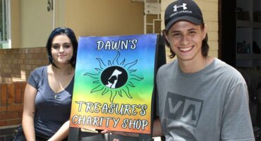 Dark headed girl and boy wearing a cap