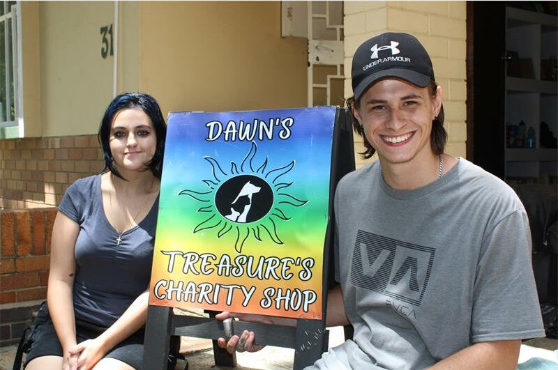 Dark headed girl and boy wearing a cap