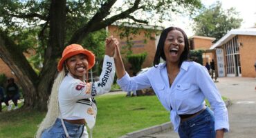 Two girls giving a hi-five