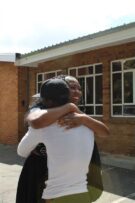 Woman embracing a man wearing white