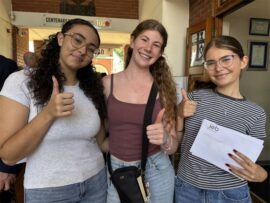Three girls showing a thumbs up
