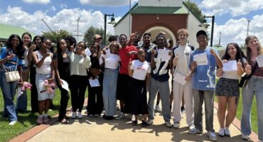 Group of kids holding envelopes and smiling