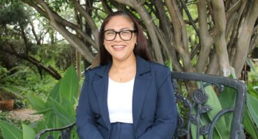 Coloured woman sitting among trees