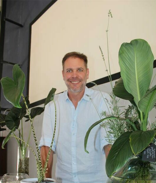 Man standing a display of plants
