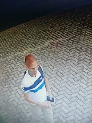 Woman with red hair and glasses