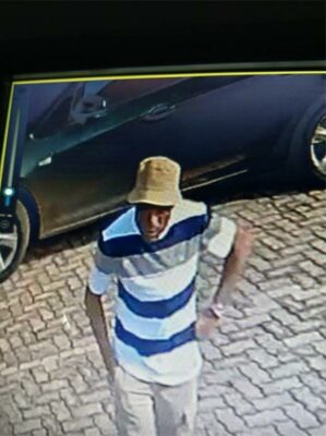 Photo of a man with a bucket hat and stripped shirt