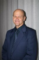 Bald man wearing a blue shirt