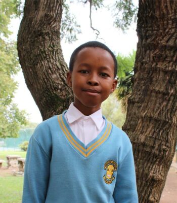 Black boy with light blue school uniform