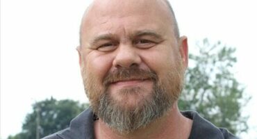 Bald man wearing a black shirt