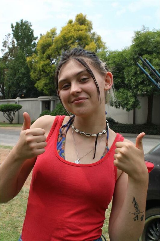 Young woman wearing a red shirt.