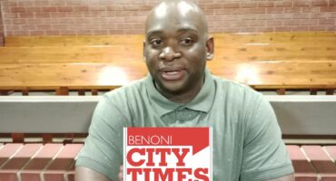 Black man wearing a green shirt