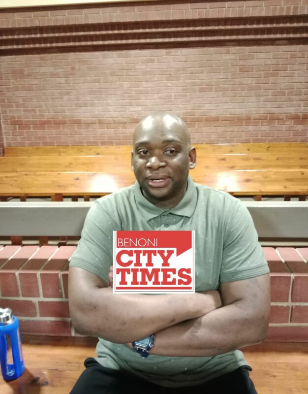 Black man wearing a green shirt