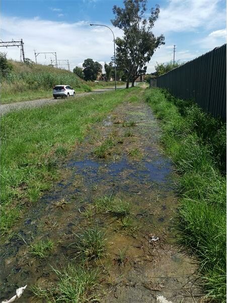 Learners were forced to walk along the railway line on February 2 after overnight rain flooded the road and pavement leading to the school.