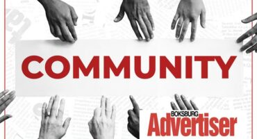 Image of multi coloured hands surrounding the word Community
