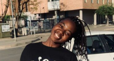 A lady smiling with her head tilted.