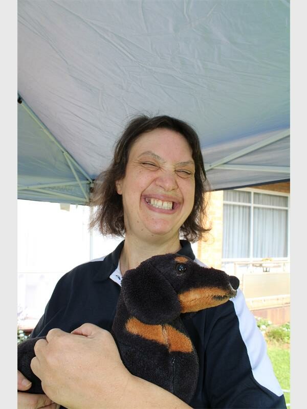 White woman holding a plush dog