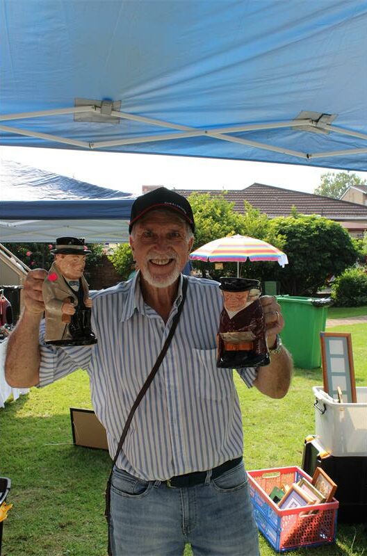 Elderly white man holding novelty steins