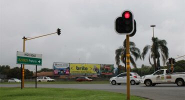 Traffic intersection with working lights and cars passing through