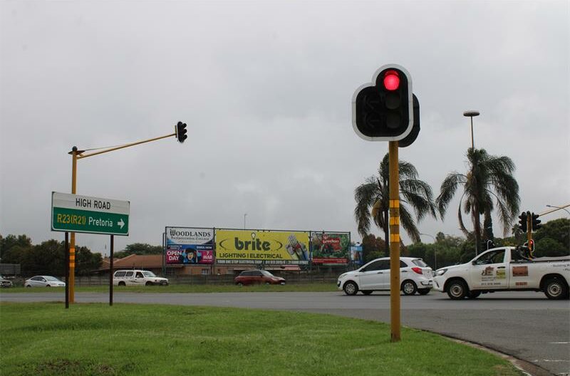 Traffic intersection with working lights and cars passing through