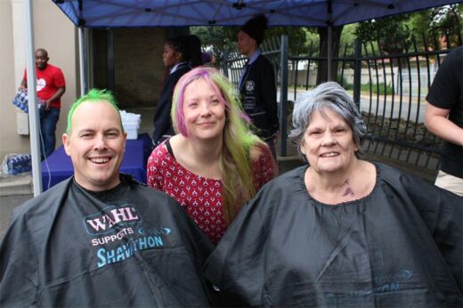 Three people, two woman and man with brightly coloured hair