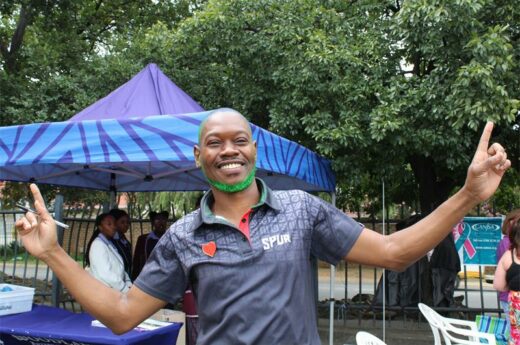 Black man wearing a Spur shirt