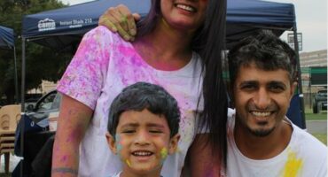 Indian family covered in paint powder