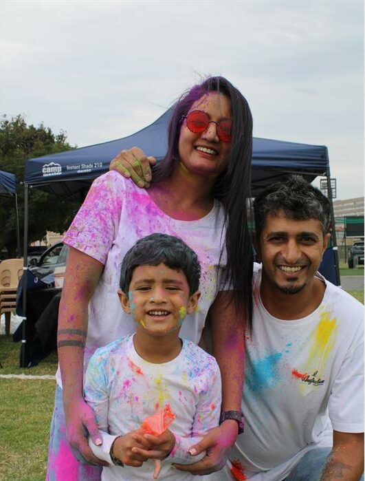 Indian family covered in paint powder