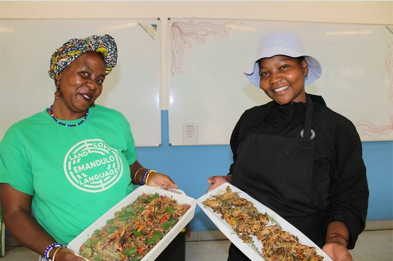 Two black women holding plates of food