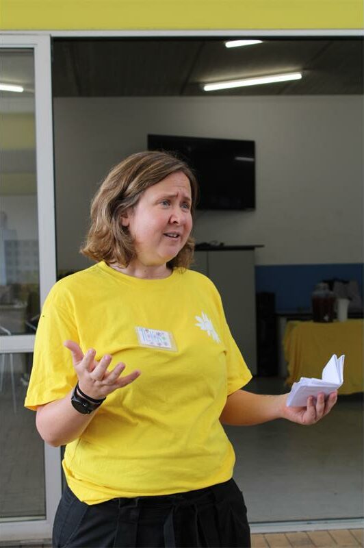 White woman wearing a yellow shirt
