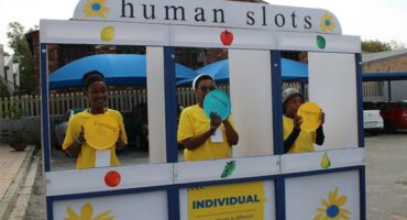 Three black women standing in a carnival game