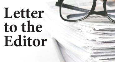 A black and white image depicting a stack of papers, reading glasses and a pencil next to the words Letter to the Editor.